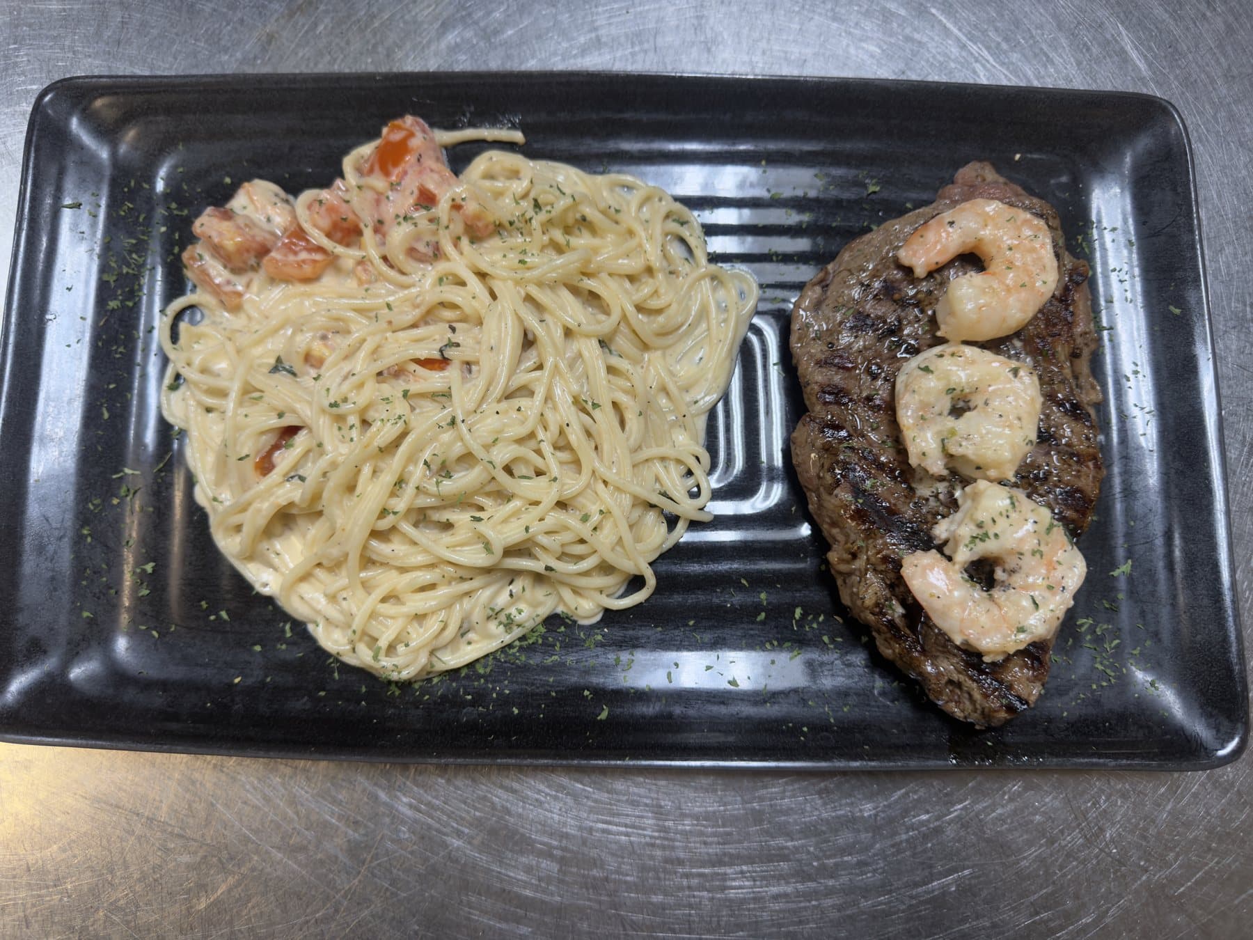 Steak Napoli's: grilled ribeye with sautéed shrimp and spaghetti, Napoli's Lincoln NE