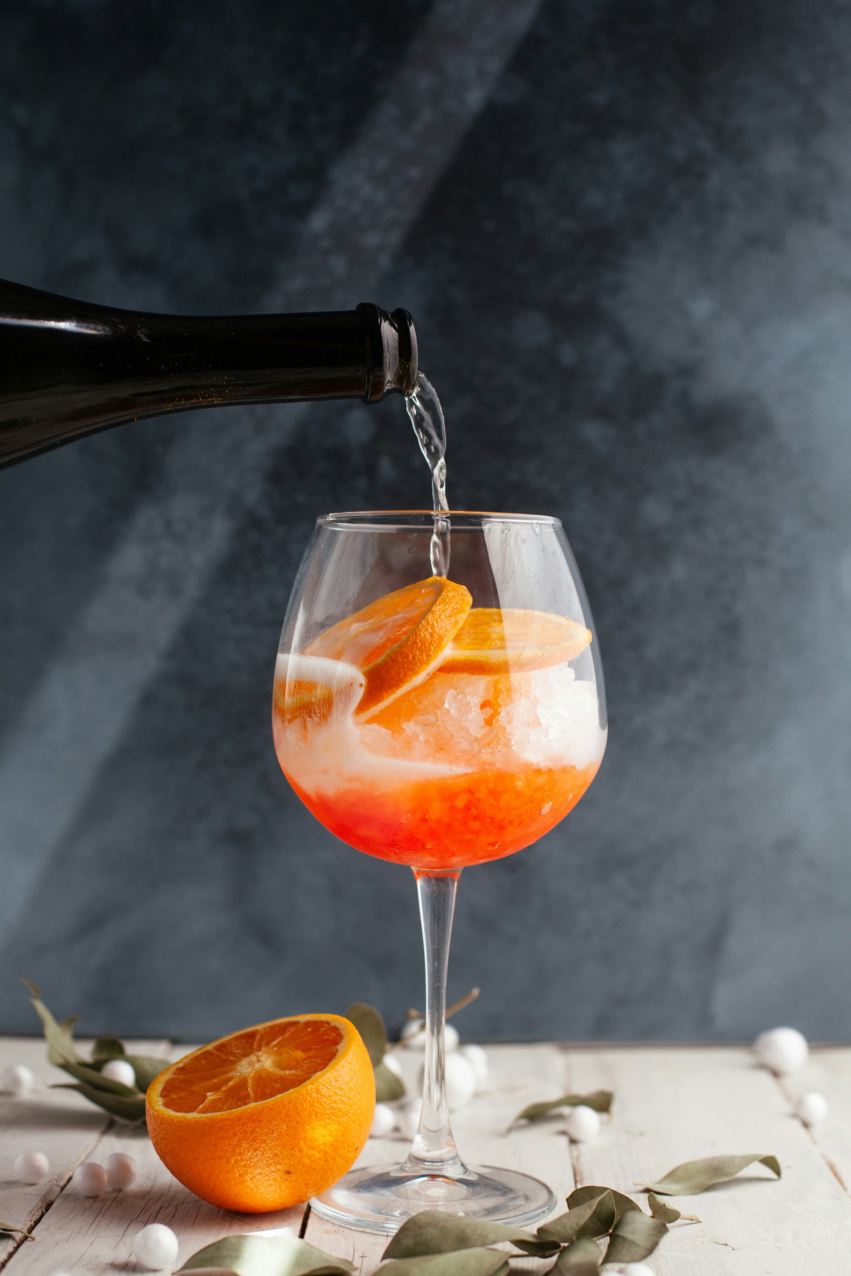 Orange spritz cocktail being poured